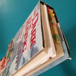 A hardcover copy of The Dark Is Rising Sequence,. The book has bent corners and several bookmarks in it.