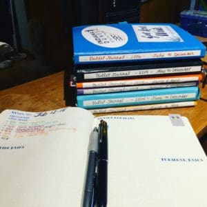 Photo of my stack of Bullet Journal notebooks