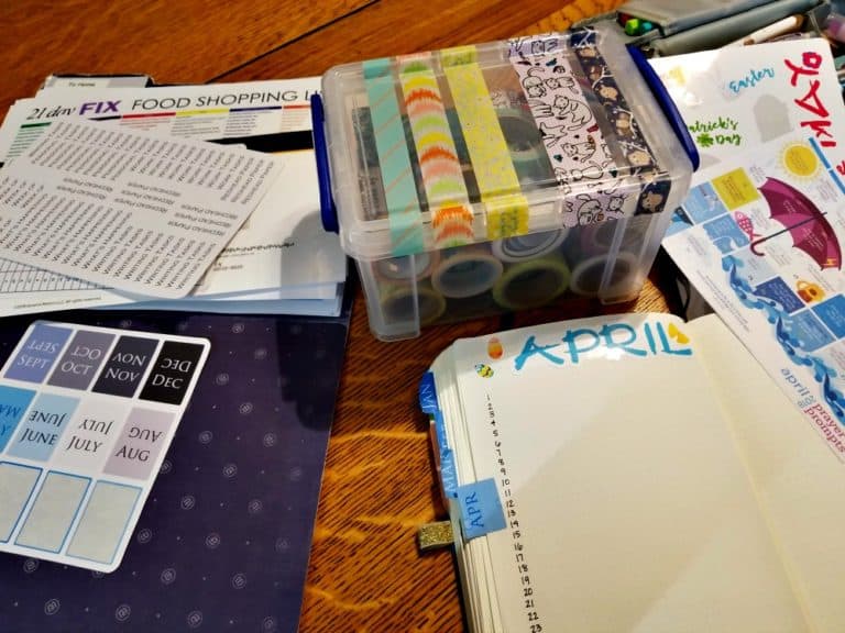 Planning process: A table spread with washi tape, stickers, and a Bullet Journal